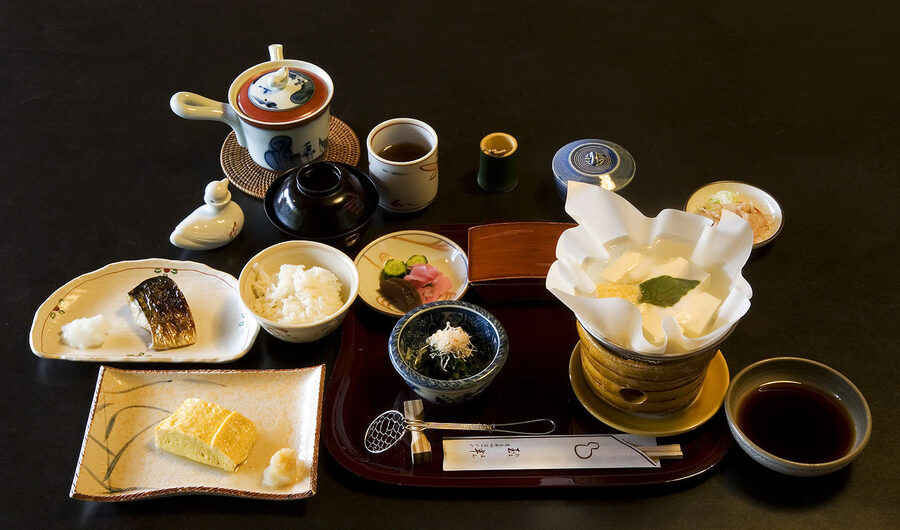 Traditional ryokan breakfast tray with fish, tofu and rice