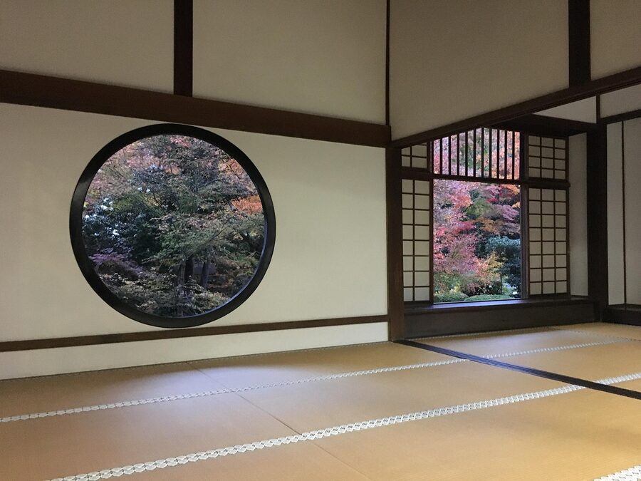 Tatami room with autumn leaves visible through screens