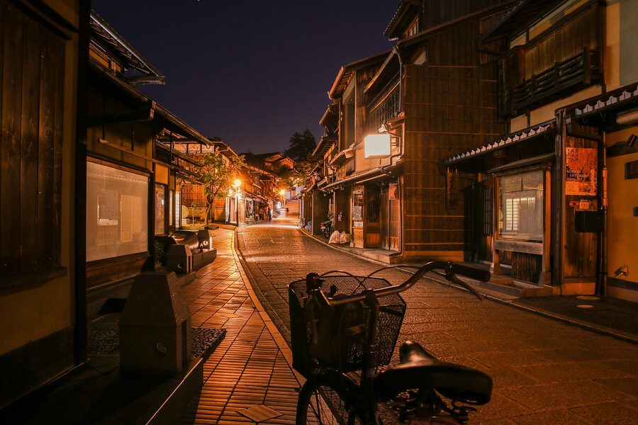 Quiet Kyoto residential street with a bicycle at night