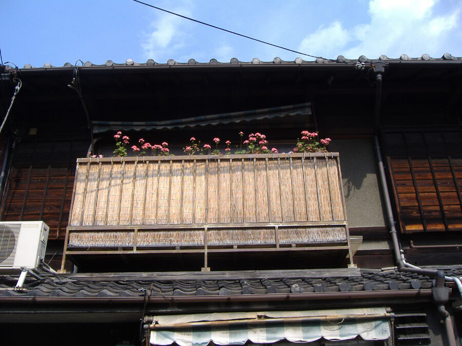 Restored Kyoto machiya exterior with lattice front