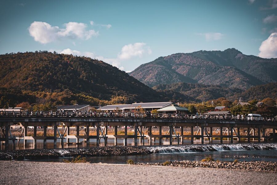 Arashiyama riverside town with mountain backdrop and boats on the water