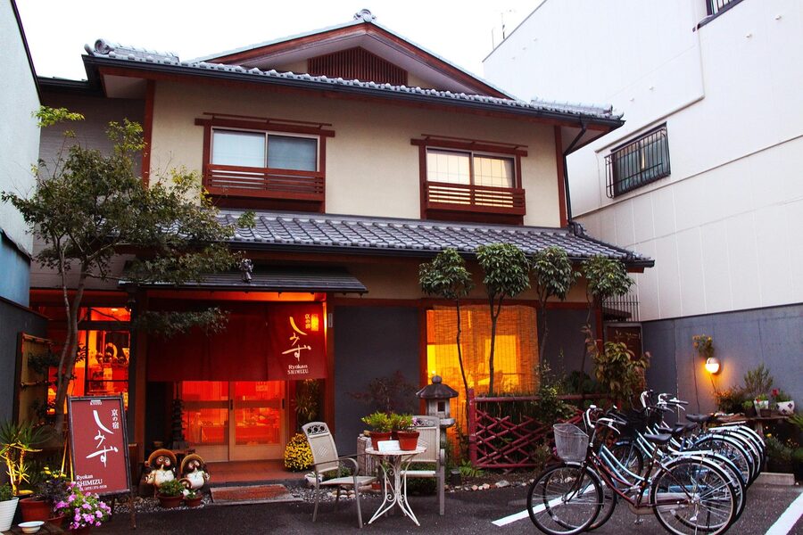Traditional Kyoto ryokan with evening lighting and lanterns