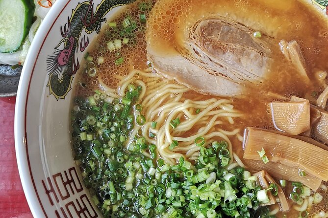 Home style Ramen and Homemade Gyoza in Kyoto - Adding cucumber pickles to the table